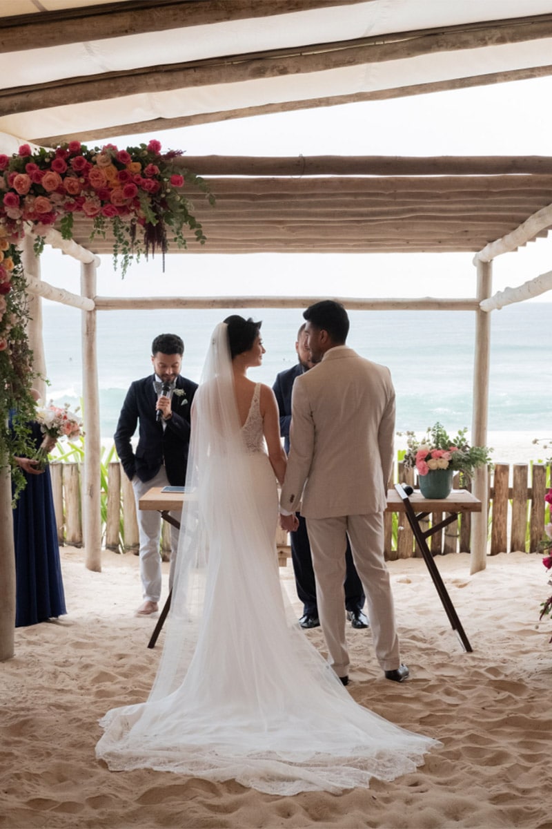 Trouwceremonie op strand bloemen